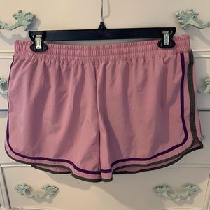 Light pink and purple XL champion running shorts.
